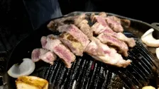 Korean BBQ cooking on a tabletop grill during the Seoul experience