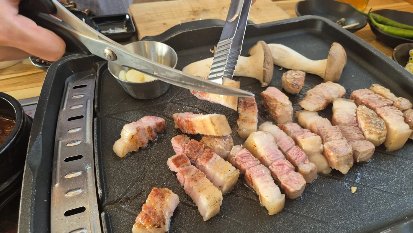 Korean BBQ cooking on a tabletop grill during the Seoul experience