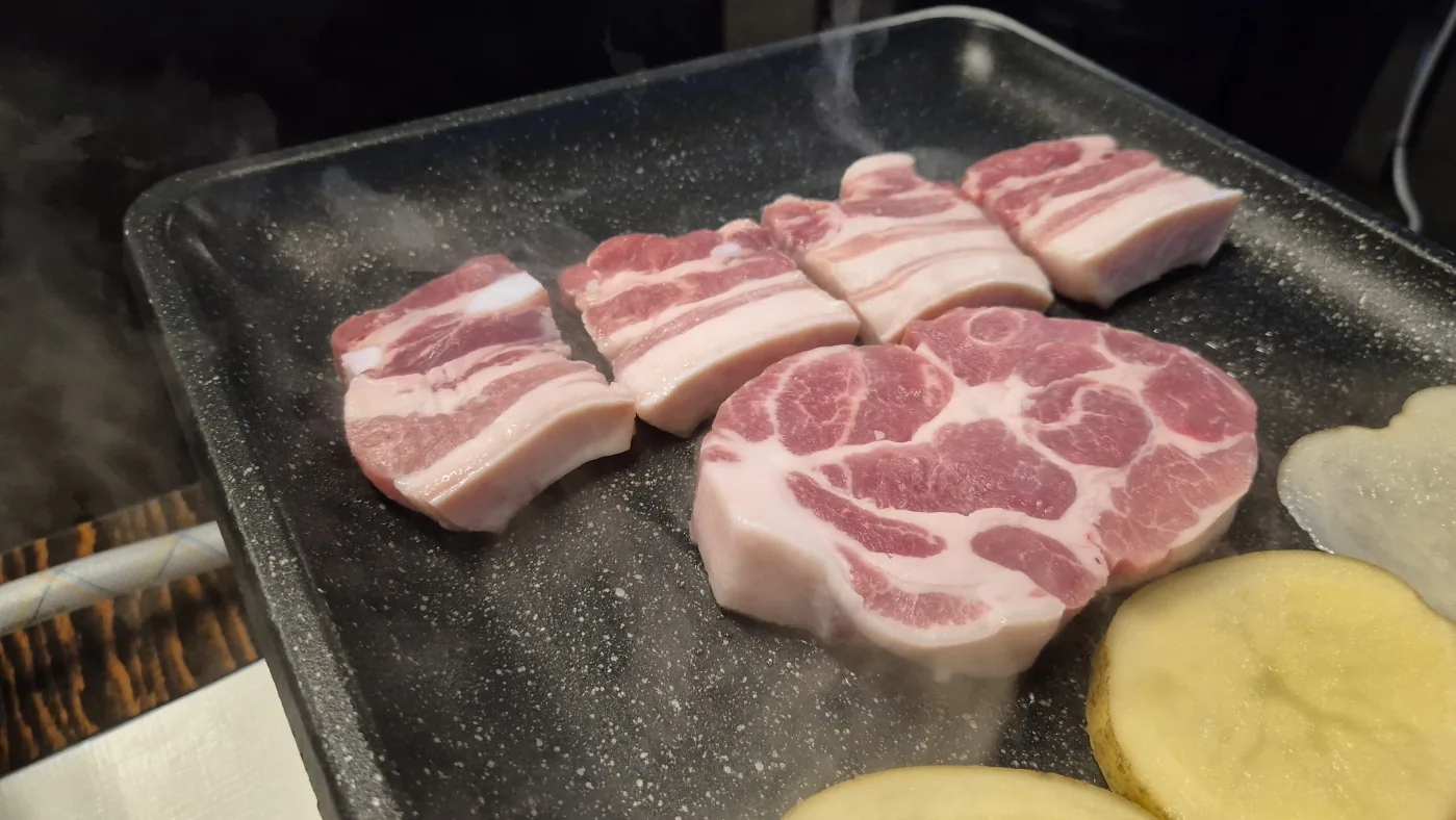 Korean BBQ cooking on a tabletop grill during the Seoul experience